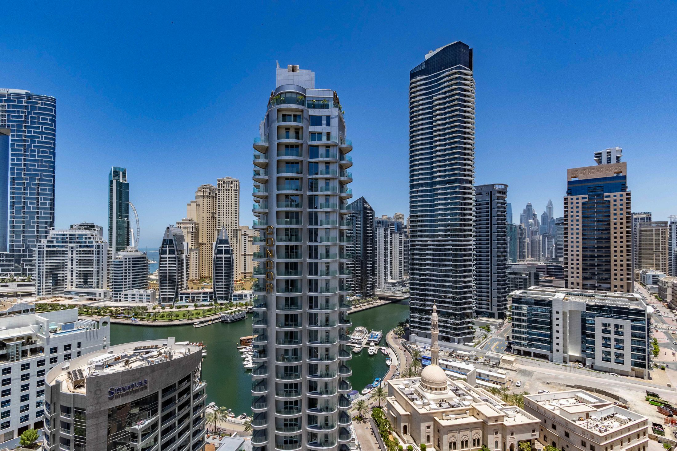 Dubai Marina’s skyline and waterfront beneath a blue sky